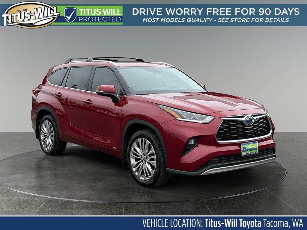 2022 Toyota Highlander Hybrid Platinum in Ruby Flare Pearl — front three-quarter view